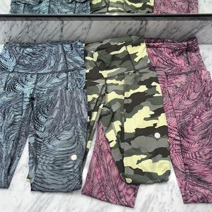 3 pair of Lululemon size 2 leggings. All with pockets on the back and sides.